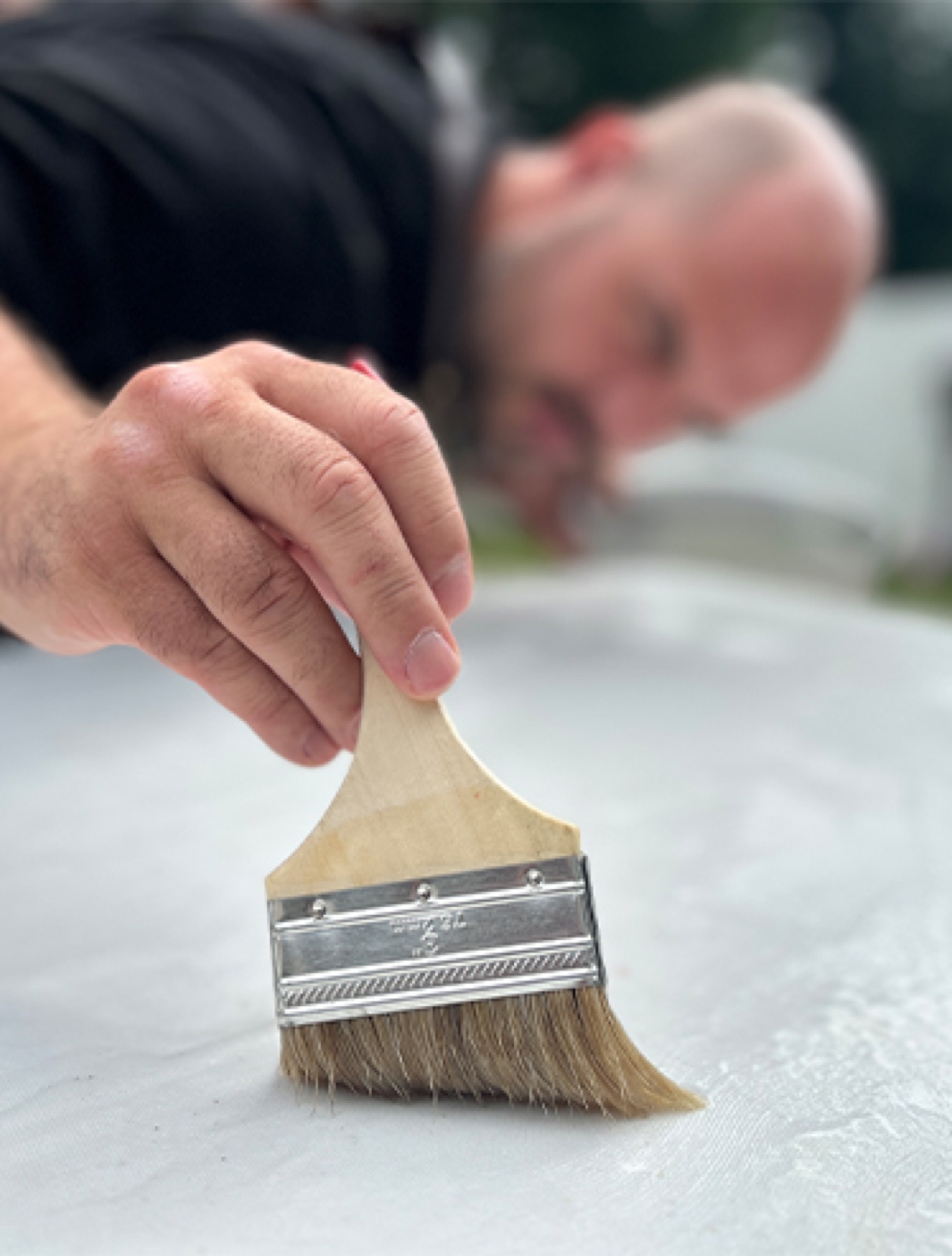 Pasting paper with a wide brush